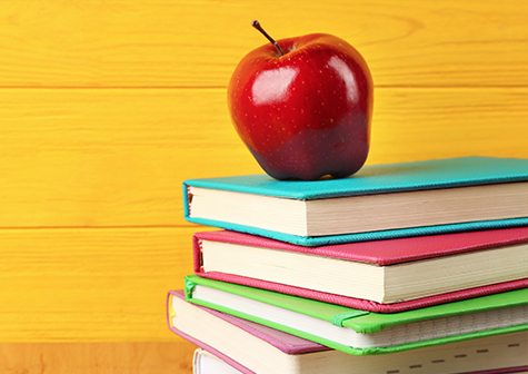 Stacked books with an apple
